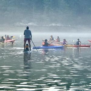 Andy Hollon and his pup Birdie paddleboard together in one of the Y's past Rowgattas. Courtesy of Brooke Hollon 