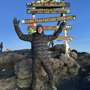 Greg Godkin, 53, celebrates reaching one of the world's seven summits and reaching his fundraising goal. Courtesy of Greg Godkin.