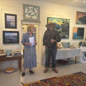 Diana Kerr introduces artist Matt Barter to the group attending the opening reception of "Oil Paint & Brimstone," a show of Matt and his father, the late Philp Barter's work. LISA KRISTOFF/Boothbay Register
