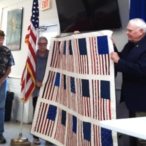 Brigadier General (Ret) William Leszczynski (right) receives a quilt at appreciation event. JANE CARPENTER/Boothbay Register