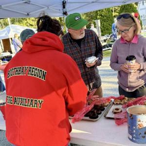 Boothbay Region Fire Auxiliary Secretary Sara Pinkham serving delicious homemade treats to auction goers. Photo by Katie Cunningham 