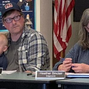 Edgecomb School Committee member John Allen, left, had an extra duty Sept. 9, tending to “Little John” during the first meeting of the new school year. BILL PEARSON/Boothbay Register little john