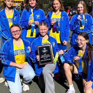 The Seahawk girls cross country team with its championship plaque. Jennifer Orchard photo Seahawk girls cross country