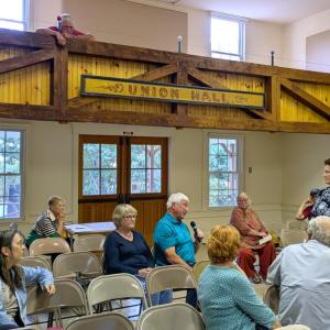 Southport Resilience Network member Kathy Jacobs, standing, takes community questions at the group’s Sept. 11 event. Photo by Sunrise Ecologic 