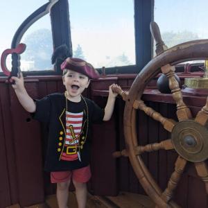 A young scallywag has a blast in the Tugboat's wheelhouse during non-profit Lighthouse Education and Nautical Studies' first annual pirate treasure hunt. Courtesy of Elaine Jones