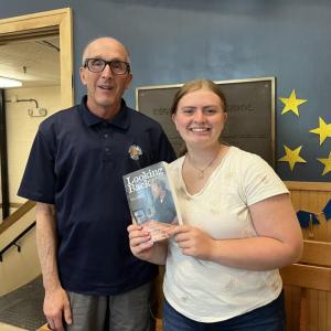 Officer Larry Brown gifts sophomore Addie Barter, 15, with a copy of "Looking Back Vol 2." so she can learn about her great uncle, Gordon Tibbetts. Courtesy of Larry Brown Officer Larry Brown gifts sophomore Addie Barter, 15, with a copy of "Looking Back Vol 2." so she can learn about her great uncle, Gordon Tibbetts. Courtesy of Larry Brown