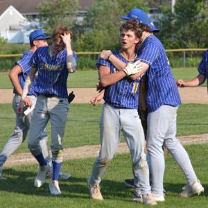Liam Jacobs gets a hug from Aiden Locke after scoring the winning run in the last inning rally by the Seahawks against Buckfield Thursday, June 12. KEVIN BURNHAM/Boothbay Register