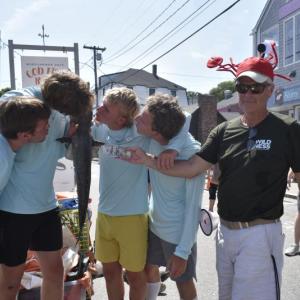 Schmakers Bay (BHYC) members yuk it up for this year's winning fish relay team photo as Jack Herger (FWJD) presents them with the $100 prize. LISA KRISTOFF/Boothbay Register