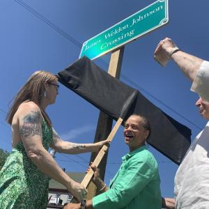 From left, Heather Jones and State Sen. Rachel Talbot Ross unveil one of the new signs naming the Main Street, Wiscasset railroad crossing James Weldon Johnson Crossing, as Terry Heller holds a phone on which Johnson’s great niece Melanie Edwards and Tony Hill, past lawmaker in Johnson’s native Florida, attend via Zoom June 26. Johnson, the poet-civil rights advocate who wrote the words to “Lift Every Voice and Sing,” died in a car-train crash at the crossing in 1938. SUSAN JOHNS/Wiscasset Newspaper 