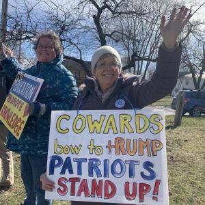 Alna's Sherry Lyons waves to motorists during a pro-federal funding for libraries rally April 10 at the bottom of Wiscasset Common. SUSAN JOHNS/Wiscasset Newspaper