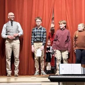 Principal Shawn Gallagher with sixth grade students, from left, Jonah Fessenden, Shepard Griffith and Aurora Wallace. Courtesy of Eileen Higgins/SCS