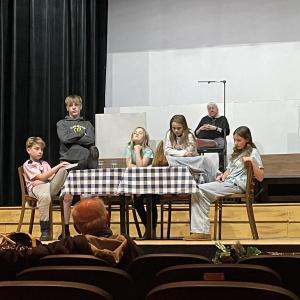 Rehearsal scene from "The Best Christmas Pageant Ever: The Herdman’s, from left: Rocklan Megaro, Finn Sullivan, Fern LeMay-Dorval, Cora Wissman, and Elliot Birrell, rehearse a scene for Director John Mulcahy. Zora Margolis, who plays Mrs. Armstrong, watches from upstage. Courtesy of LCCT