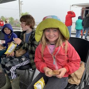 Edgecomb’s Olive Emerson, 8, looks up from her turkey and cheese sandwich at Wormfest in Wiscasset May 31. Also enjoying lunch under the tent were Boothbay’s Arbor Lewis, 8, and Austin Lewis, 10. SUSAN JOHNS/Wiscasset Newspaper 