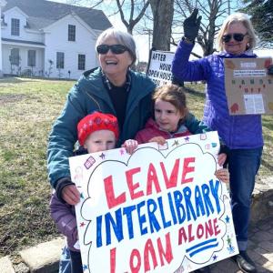 Rita Arnold and her granddaughters, June and Faye, protest the federal funding cuts to libraries nationwide. ISABELLE CURTIS/Boothbay Register