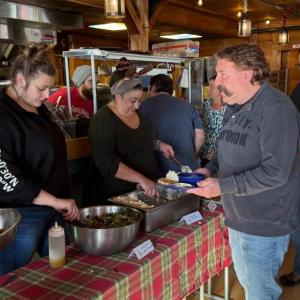 Sponsor Rich Elliott hits the buffet served by Winter Page and Heather McDaniels.