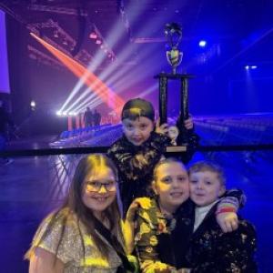 Evelyn Michaud, Lily Billings, Louie Mirabile and Oscar Mirabile pose for a photo with the team trophy while waiting for the theater to open. Emily Mirabile photo