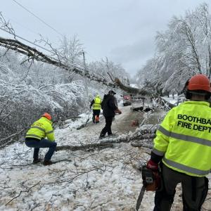 Mike Leighton, owner of Midcoast Building and Excavation assisting BFD Firefighters on West Side Road on Barters Island. Courtesy photo