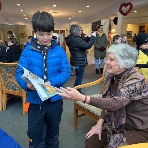 A BRES third grader shares a book with Village resident Leigh Sherrill. Courtesy photo