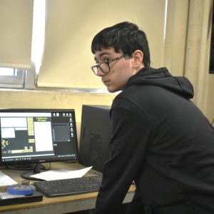 Brandon Seigers checks over the design. ISABELLE CURTIS/Boothbay Register