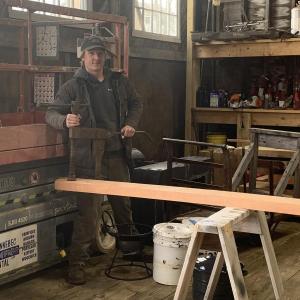 Carpenter Drake Loomis shows off a sealing clamp, used to wedge planks together. ISABELLE CURTIS/Boothbay Register