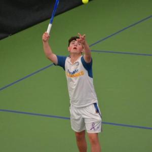 Alex Ross, no. 1 singles, serves against his Madison opponent. KEVIN BURNHAM/Boothbay Register