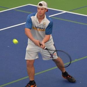 Griffin Yereance makes a backhand return against his Madison opponent. KEVIN BURNHAM/Boothbay Register