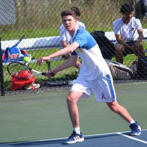 Harry Hinckley, playing first doubles with Ronan Drage, sets to return a serve against North Yarmouth Academy on May 19. KEVIN BURNHAM/Boothbay Register