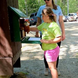 Martha Cowdery and Mike Tomko's daughter, Whitney Lytle, and granddaughter, Eben Anderson, 8, get on the geocaching fun at a spot in Dodge Point, Maine. Courtesy of Mike Tomko. 