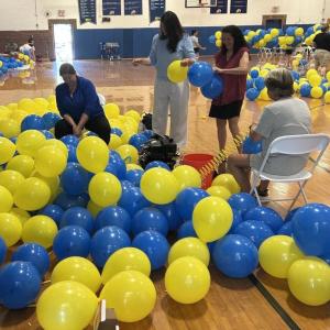 Busy as can be blowing up balloons on June 9. KEVIN BURNHAM/Boothbay Register