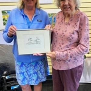 Displaying Tim Sample's artwork are his sister, Debbie, and thrift shop volunteer Marion Coleman. Courtesy of St. Andrews Auxiliary