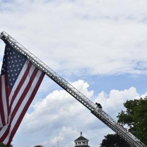 This man climbs down carefully after unfurling the flag,  Chris and Dave Gagne. LISA KRISTOFF/Boothbay Register