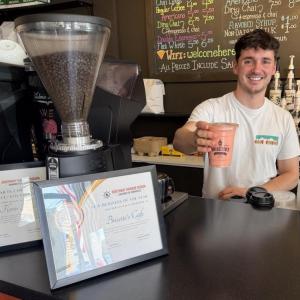 Florin Iuga serves up a smoothie at his shop Brisetto's Second Cup. Iuga is displaying his patriotism as America celebrates its 250th anniversary with giant 12-foot by15-foot American flag on his storefront. BILL PEARSON/Boothbay Register 