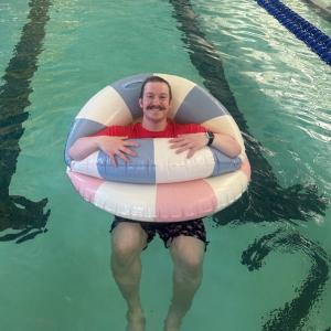 David Washburn floating in the pool after teaching a swim lesson. Courtesy of Emily LeGree