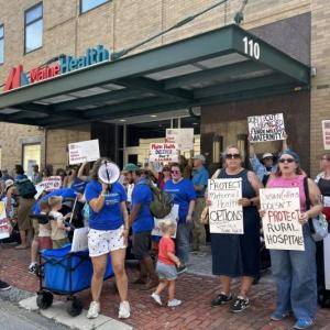 Members of Miles Delivers Action Coalition marched to MaineHealth in Portland to protest the potential closure on Saturday, August 1. Photo by Megan Blonigen