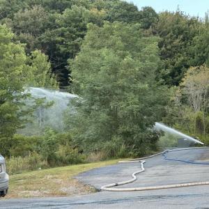 Water is dispersed onto the propane tanks and area behind the Meadow Mall. Mark Sullivan photo