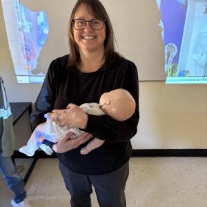 Jennifer Harris, of First Point Training, holds a training infant used in the American Red Cross Babysitter Training. Courtesy of Raye Leonard