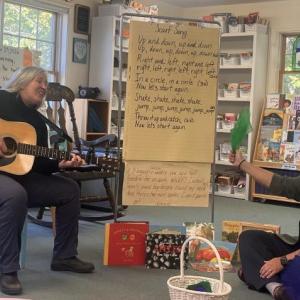 At CTL's Song and Story, Annie Nixon plays guitar while Katy Inman pairs the music with books that engage young learners and their caregivers. Courtesy of CTL