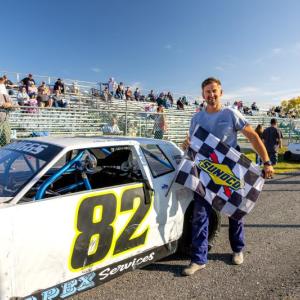 Chaz Briggs with the checkered flag. Jasen Dickey photo