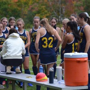 Coach Jax Hepburn talks with her players before the start of a recent game. KEVIN BURNHAM/Boothbay Register