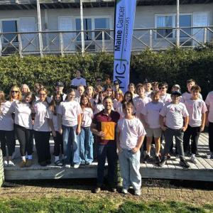 Boothbay Region Elementary School eighth graders and teachers present $1,500 to Maine Cancer Foundation Executive Director Ray Ruby in the Whale Park Oct. 30. KEVIN BURNHAM/Boothbay Register
