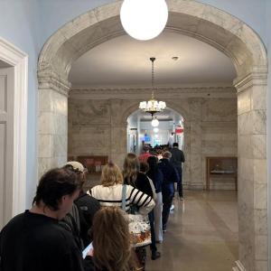 Voters lined up at Portland City Hall for in-person early absentee voting midday on Oct. 28, 2026, waiting more than an hour to cast their ballots. Photo by Emily Bader
