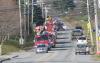 Boothbay Harbor Police Officer Larry Brown leads the fire engines in the parade for Ellie Logan. KEVIN BURNHAM/Boothbay Register