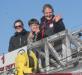 Ellie Logan waves to people lining the streets during her parade through downtown Boothbay Harbor November 9. Seated with her are her good friend, Miranda Sherman, and  her cousin, Thomas Wilcox, center. KEVIN BURNHAM/Boothbay Register