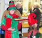 An elf (Erica Eames) offers a tray of cookies to those waiting to see Santa at the Memorial Library. GARY DOW/Boothbay Register