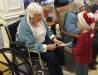 Jeanette Orne gets a holiday card from Ronan Cullina wearing a Santa hat. RYAN LEIGHTON/Boothbay Register