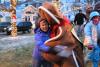 The Gingerbread Man wasn't trying to run away from anyone on Saturday. Here, Mary Kaler happily gets wrapped up in his sweet arms. SUE MELLO/Boothbay Register