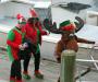 Elves (Ben Rankin and Lisa Walby) and the Christmas Moose (Susan Endicott) make their way up the town dock ramp to greet Santa's friends. GARY DOW/Boothbay Register