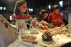 From left, Iris Pope and Tabetha and Deakon Harrington decorate gingerbread houses with assorted candy during Pat Kiley’s class at the Opera House November 27. BEN BULKELEY/Boothbay Register