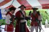 Once the British are defeated, their punishment is to do the hokey-pokey on the stage. From left, Bloodthirsty Barbara, Captain Krudbeard, and Doc in British attire. KATRINA CLARK/Boothbay Register