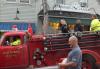 A young boy douses the crowd from the top of an old Boothbay fire truck. SUE MELLO/Boothbay Register